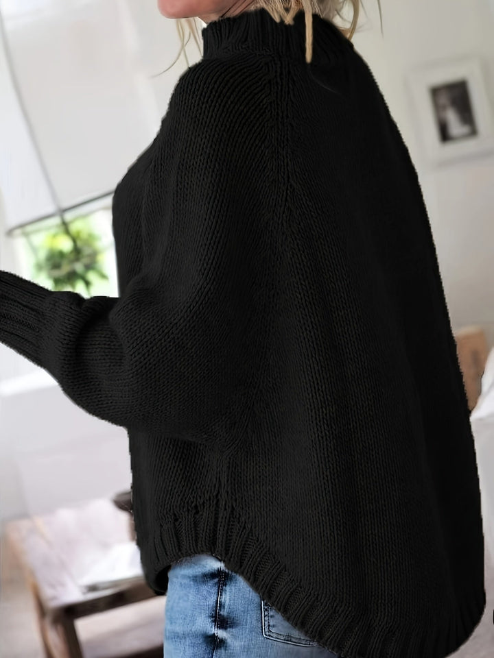 Women's high-neck textured sweater featuring batwing sleeves, flared hem, and oversized fit for fall.