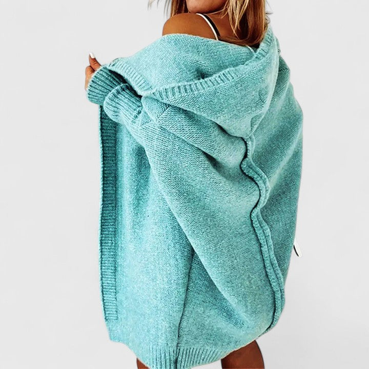 Warm, cozy women's hooded long sleeve cardigan. Stylish oversized knee-length knit for comfortable casual wear.