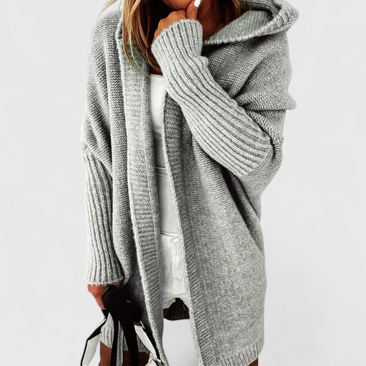 Chic women's hooded knit cardigan, comfortable long sleeve, oversized, knee-length for stylish everyday layering.