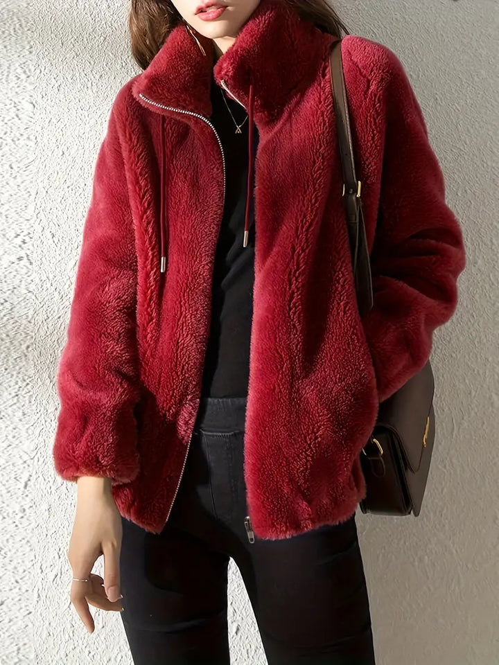 Casual women's hooded zip-up teddy jacket with drawstring, offering warmth & comfort for colder days.