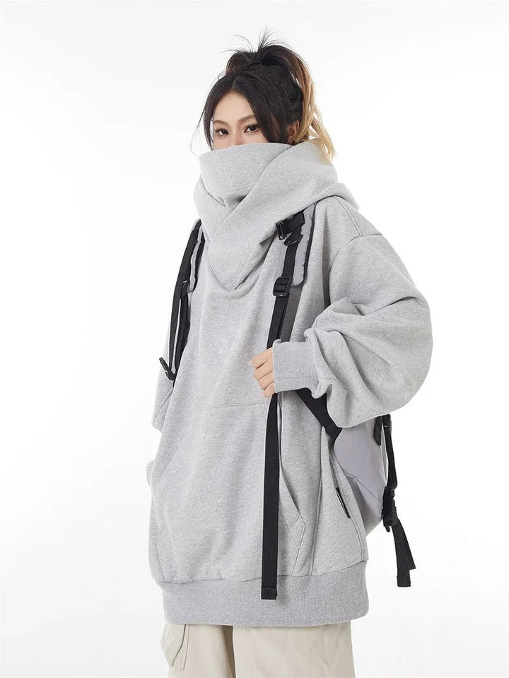 Warm women's oversized hooded sweatshirt, ideal for fall fashion and winter style. Comfortable casual top.