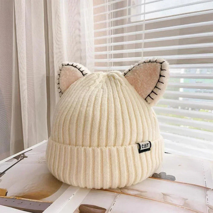 Cozy women's winter beanie with playful cat ears, knitted for warmth & chic style in cold weather.