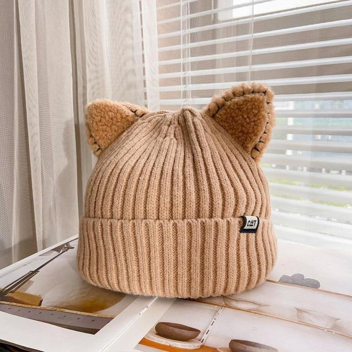 Playful women's cat ears winter beanie, a cozy & cute knitted headwear accessory for cold weather fashion.