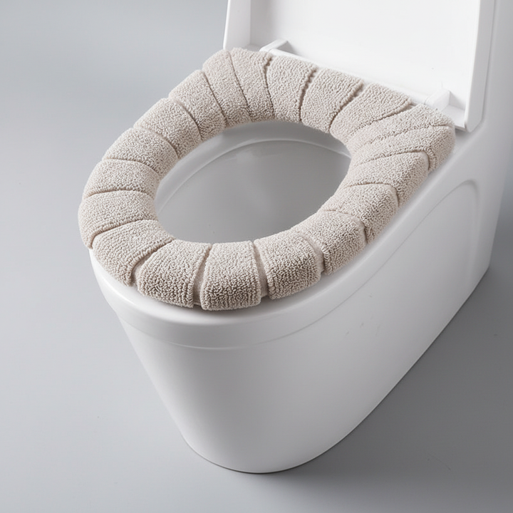 Unisex CozySeat padded toilet seat cover, front view, in white soft polyester for comfort