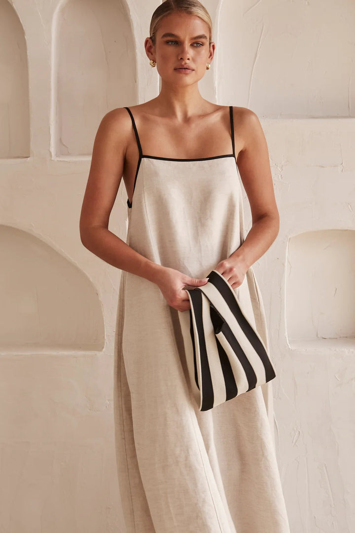 Flowy cream maxi dress with contrast trim and square neck. Oversized fit for summer fashion.