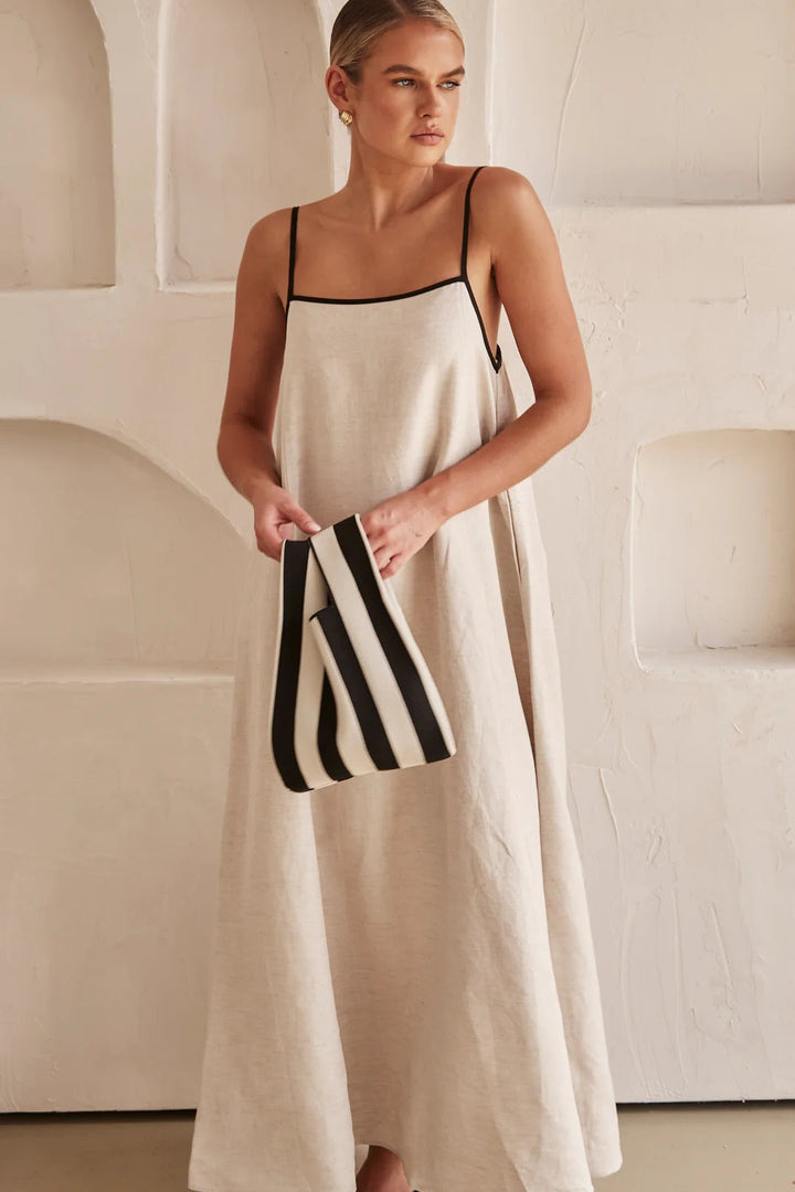 Chic women's oversized cream maxi dress, square neck, spaghetti strap, contrast trim. Resort style.
