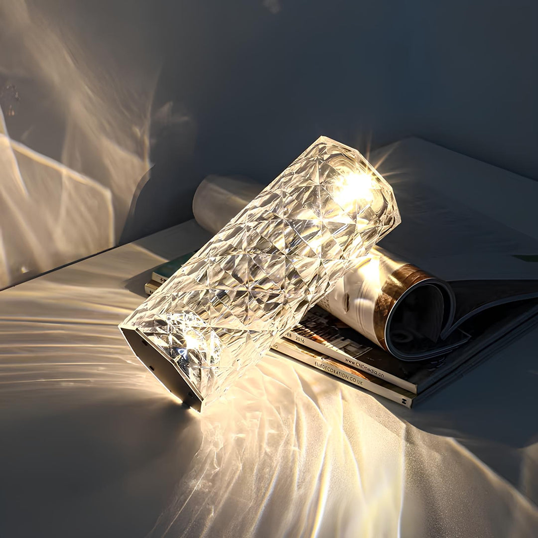 Close-up of a sparkling crystal touch lamp displaying a vibrant blue LED light, modern mood lighting