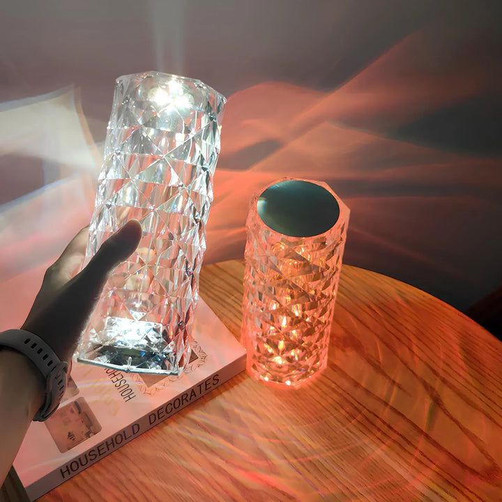 Hand touching a crystal lamp to change its 16 LED colors, demonstrating touch control functionality