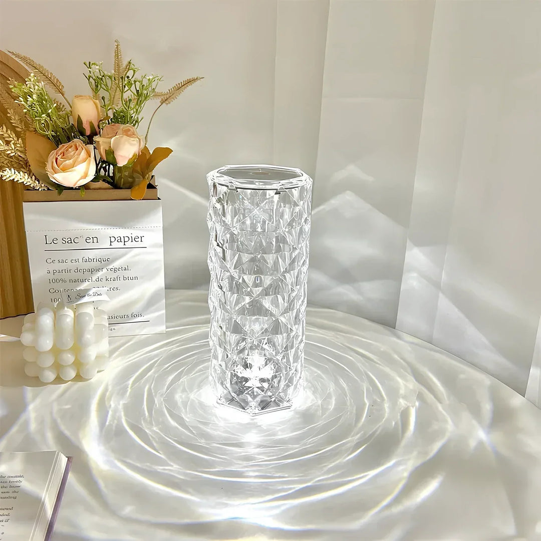 Portable crystal table lamp on a nightstand, emitting a soft pink LED light, ideal bedroom ambiance