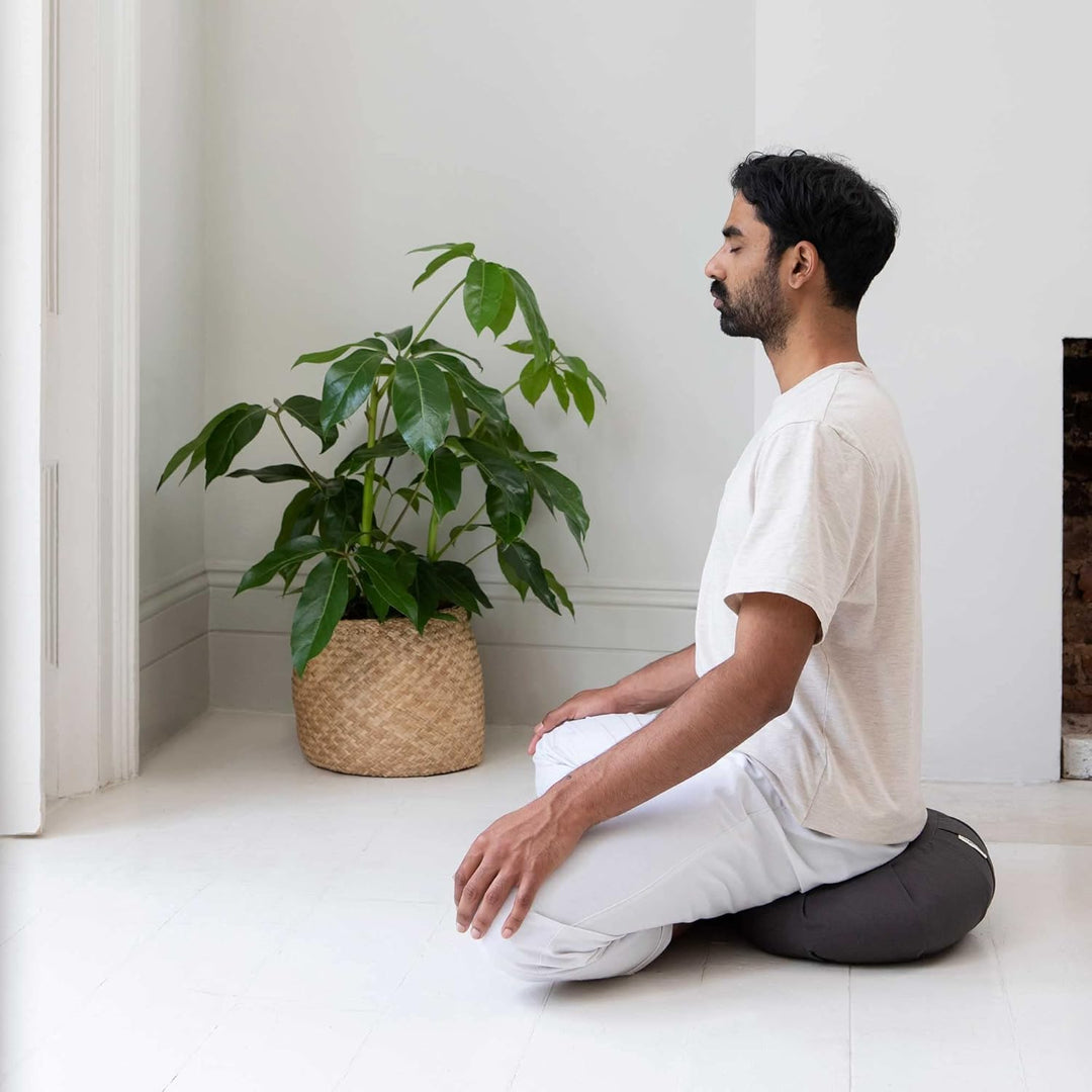 Washable organic cotton meditation cushion, curved design for optimal spine alignment & comfortable yoga practice.