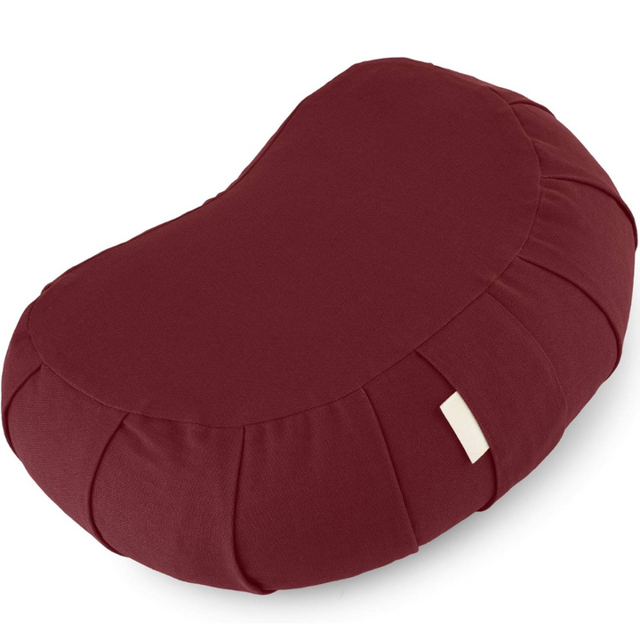 Ergonomic curved meditation cushion, organic cotton, buckwheat fill, supports comfortable long meditation sessions.