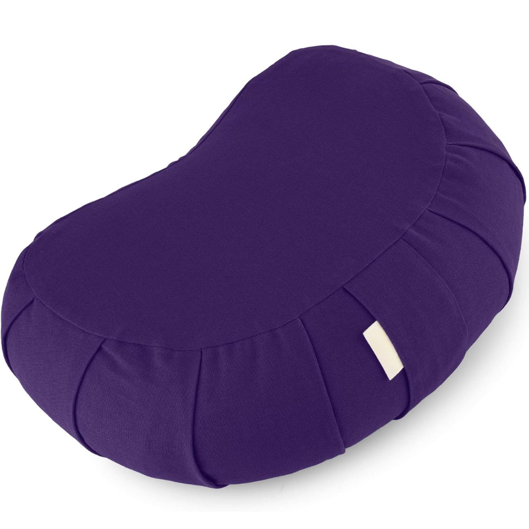 Curved organic cotton meditation cushion for improved posture, featuring a natural buckwheat fill & washable cover.