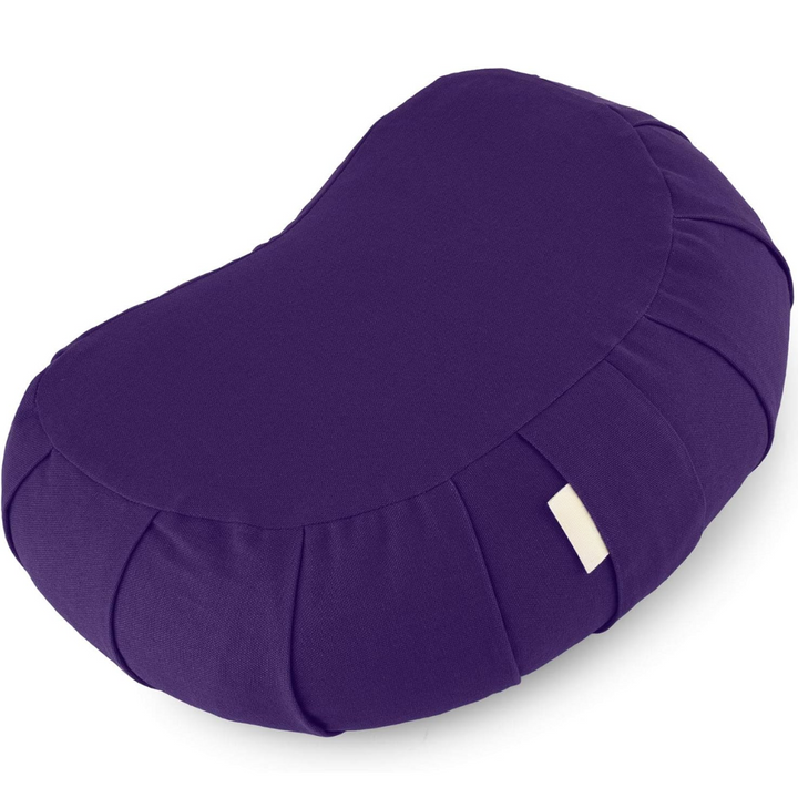 Curved organic cotton meditation cushion for improved posture, featuring a natural buckwheat fill & washable cover.