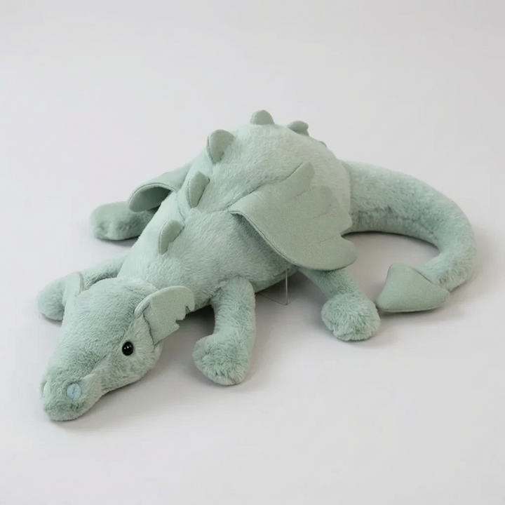 Cute green dragon plush toy with soft wings, perfect for kids' playtime. Stuffed animal for nursery decor.