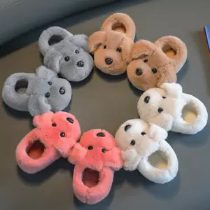 Close-up of adorable puppy face on cozy kids' slippers, featuring soft material and comfortable fit for children.