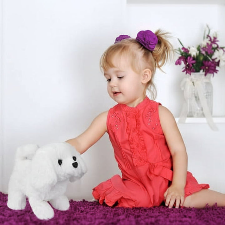 Child playing with a movable plush dog, an interactive toy for imaginative adventures. Soft stuffed animal gift.
