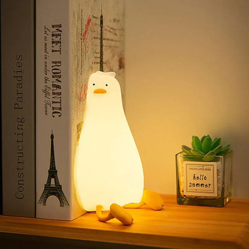 Silicone duck LED night light, QuackLite, for kids' rooms, a gentle bedside lamp for peaceful sleep.