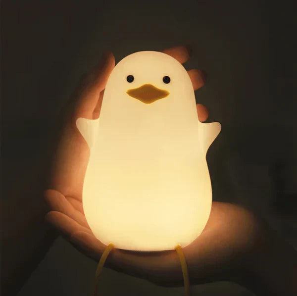 Kids' gentle glow duck night light, silicone LED sleep aid for nursery, adorable and comforting.