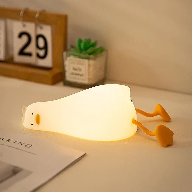 Adorable duck LED night lamp, QuackLite silicone, perfect for children's peaceful sleep and nursery decor.