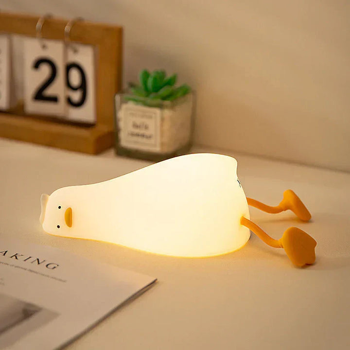 Adorable duck LED night lamp, QuackLite silicone, perfect for children's peaceful sleep and nursery decor.