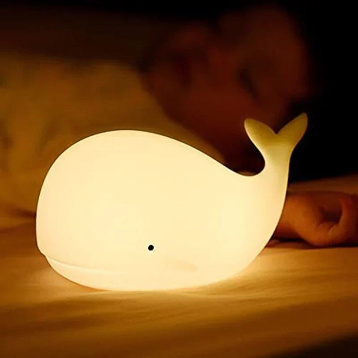 Close-up of whale night light, soft silicone material, color changing LED, perfect bedside lamp