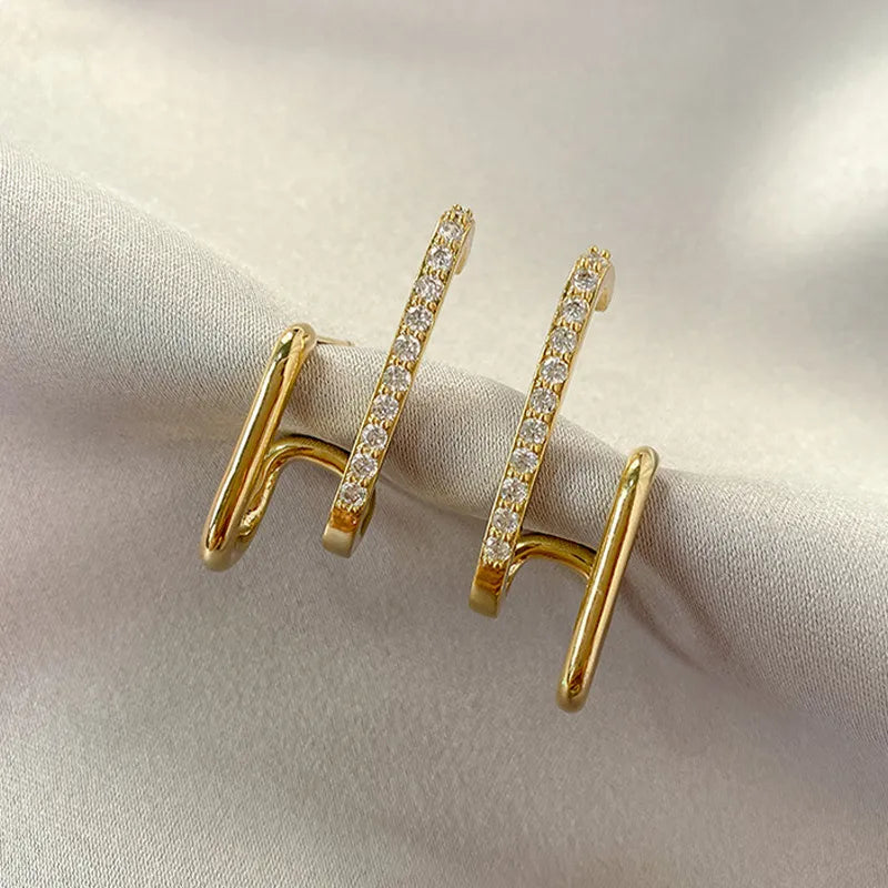 Dainty crystal claw stud earrings for women, adding elegant sparkle. Hypoallergenic gold-plated jewelry.