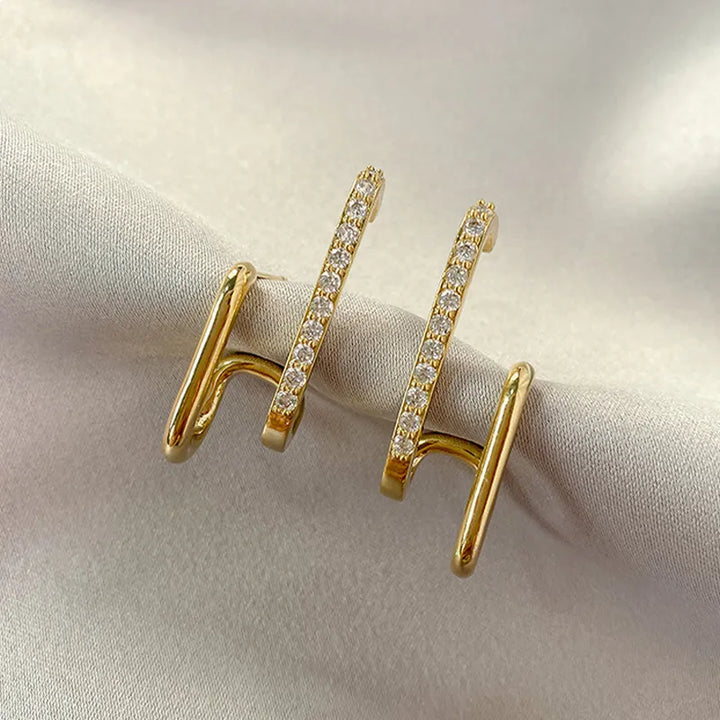 Dainty crystal claw stud earrings for women, adding elegant sparkle. Hypoallergenic gold-plated jewelry.
