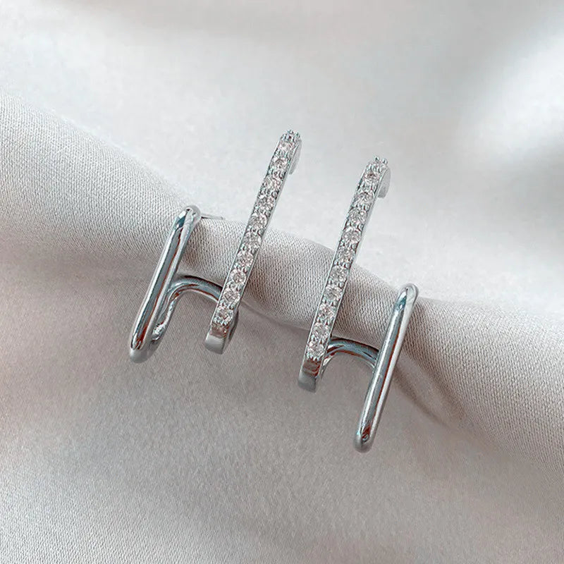 Sparkling silver crystal stud earrings, featuring a unique claw setting. Perfect dainty women's jewelry gift.