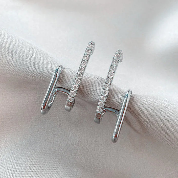 Sparkling silver crystal stud earrings, featuring a unique claw setting. Perfect dainty women's jewelry gift.