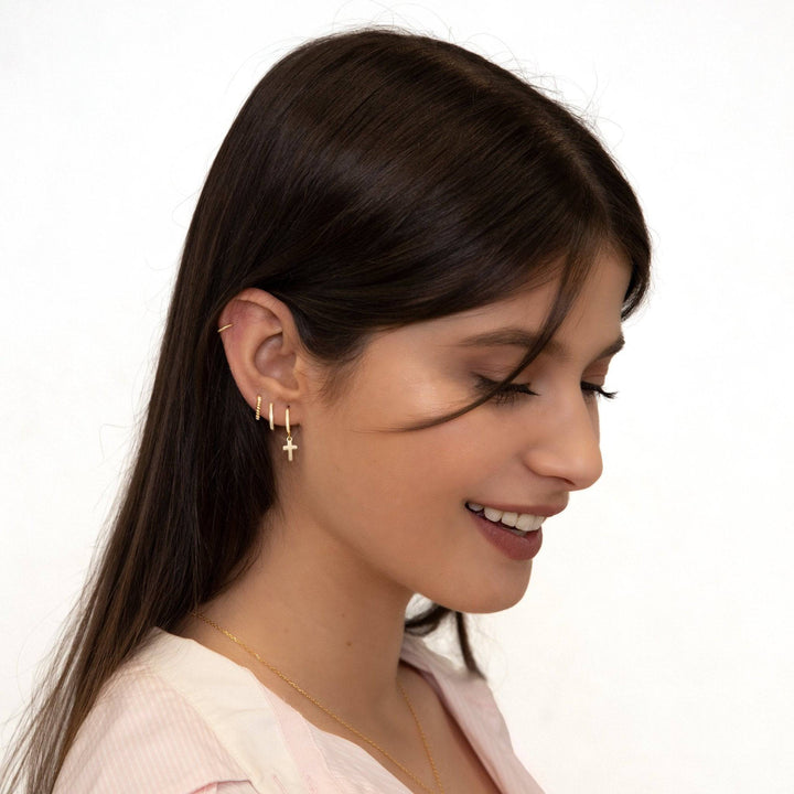 Stylish women's gold plated cross pendant and hoop earrings, perfect dainty religious fashion accessory.