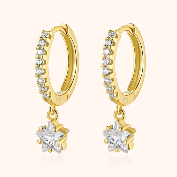Dainty gold plated sterling silver hoop earrings with hanging star charm, perfect women's celestial jewelry.
