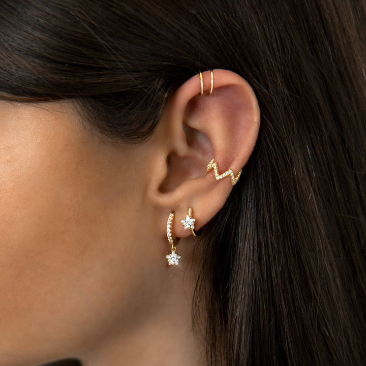 Sparkling women's star hoop earrings, gold plated sterling silver with zirconia accents, ideal celestial jewelry.