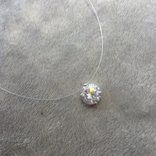 Minimalist women's zircon necklace on an invisible line, offering elegant, dainty sparkle; ideal fashion accessory.