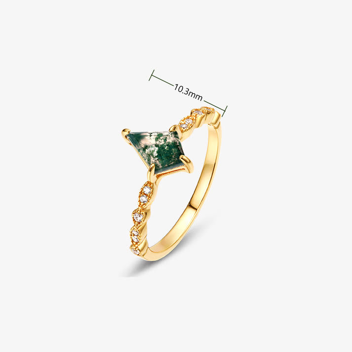 Close-up of lush green moss agate in a dainty jewelry setting, natural patterns.