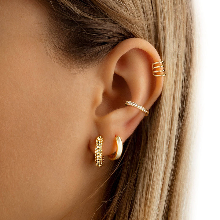 Elegant women's pearl hoop earrings, dainty design with delicate pearls on a sterling silver gold-plated hoop.