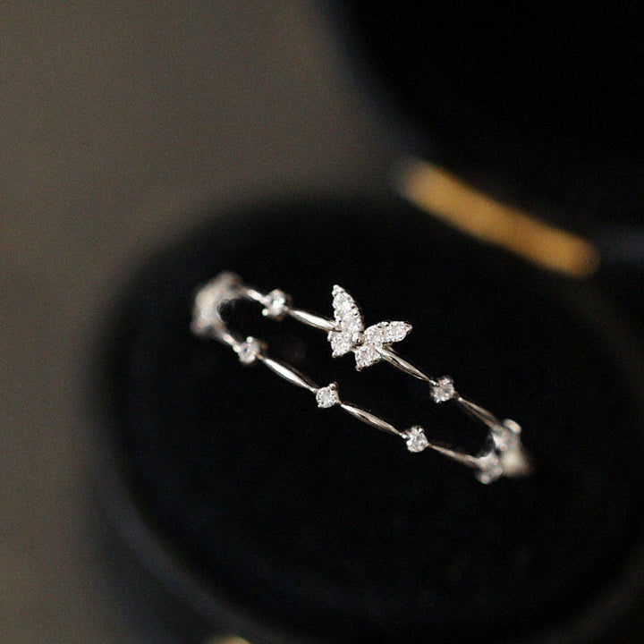 Close-up of a sparkling zirconia butterfly ring in S925 silver, a dainty and symbolic gift for her.