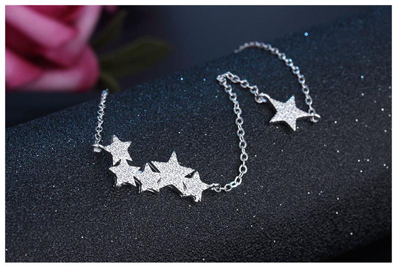 Close-up of a delicate silver star pendant on a dainty chain, elegant star jewelry for women.