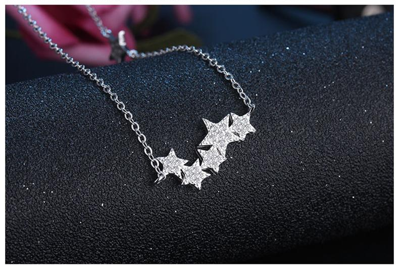 Elegant silver star necklace worn by a woman, showcasing dainty design & everyday wear appeal.