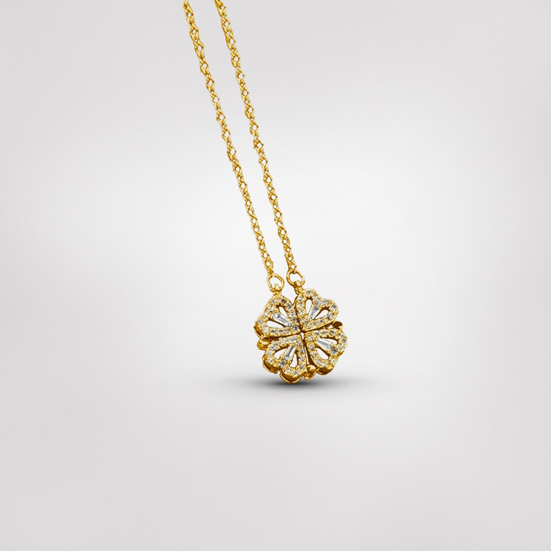 Close-up of a delicate sterling silver four-leaf clover necklace, a dainty and elegant symbolic women's charm.