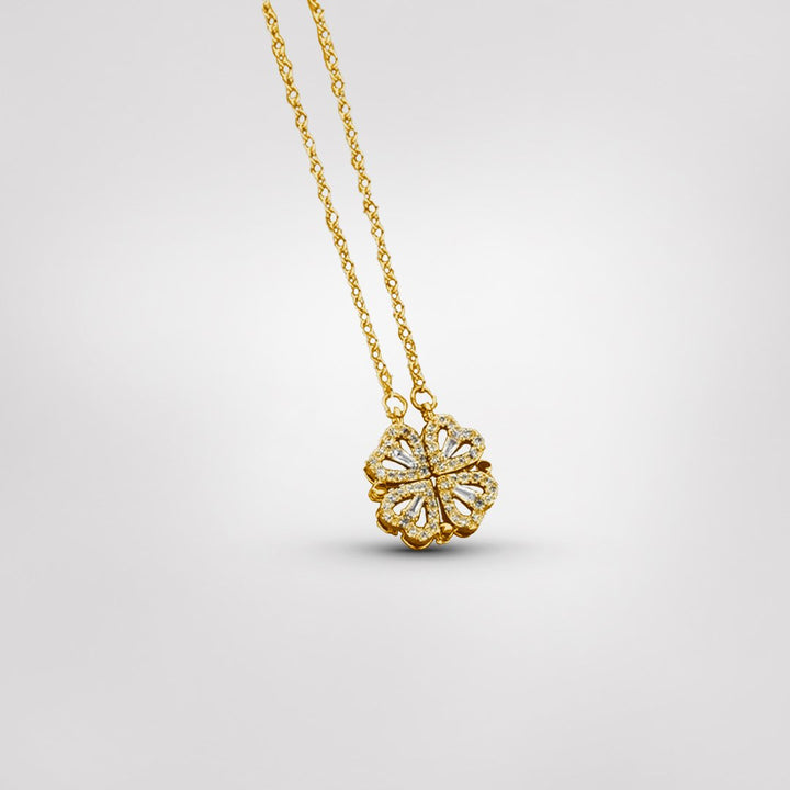 Close-up of a delicate sterling silver four-leaf clover necklace, a dainty and elegant symbolic women's charm.