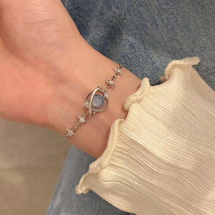 Dainty women's celestial charm bracelet, featuring elegant small star & moon charms. Adjustable delicate jewelry, perfect for her.
