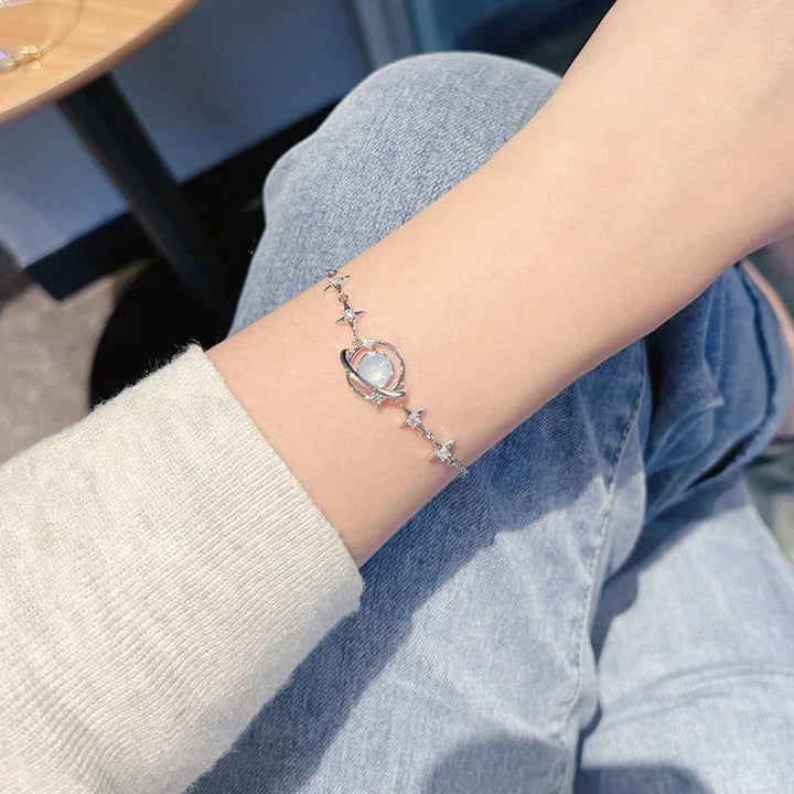 Adjustable dainty celestial charm bracelet for women, featuring delicate star & moon charms. Elegant gift for her, versatile jewelry.