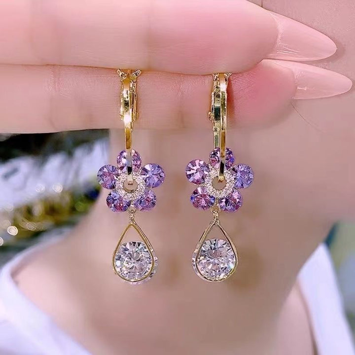 Sparkling blue crystal flower stud earrings for women, a dainty and elegant fashion jewelry gift.