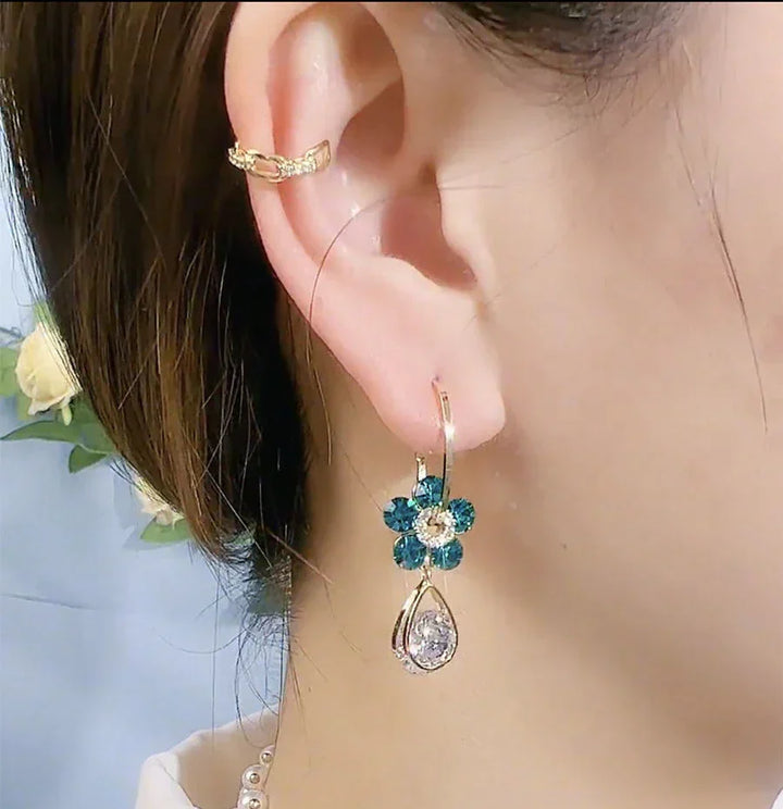 Elegant purple crystal flower stud earrings for women, dainty and sparkling, ideal for any outfit.
