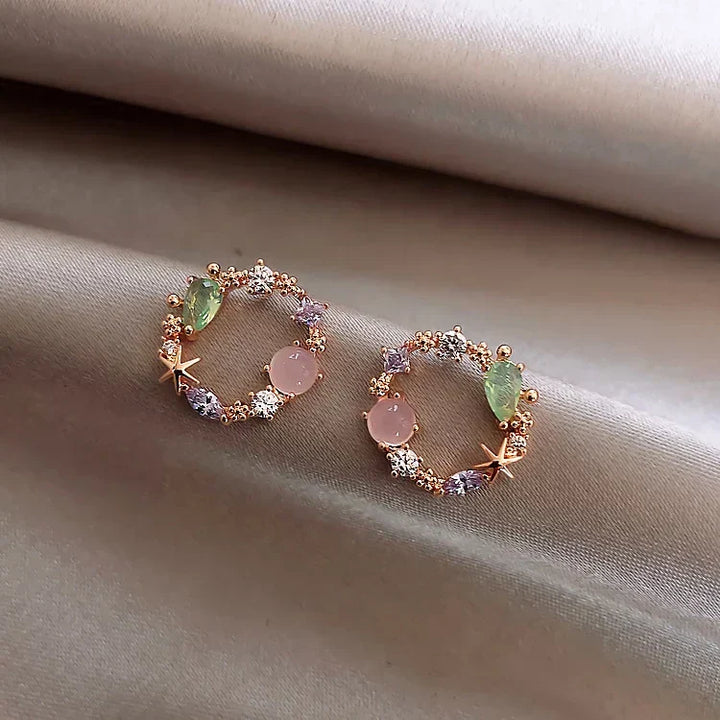 Dainty women's golden flower earrings with sparkling zirconia, elegant gold-plated floral jewelry.