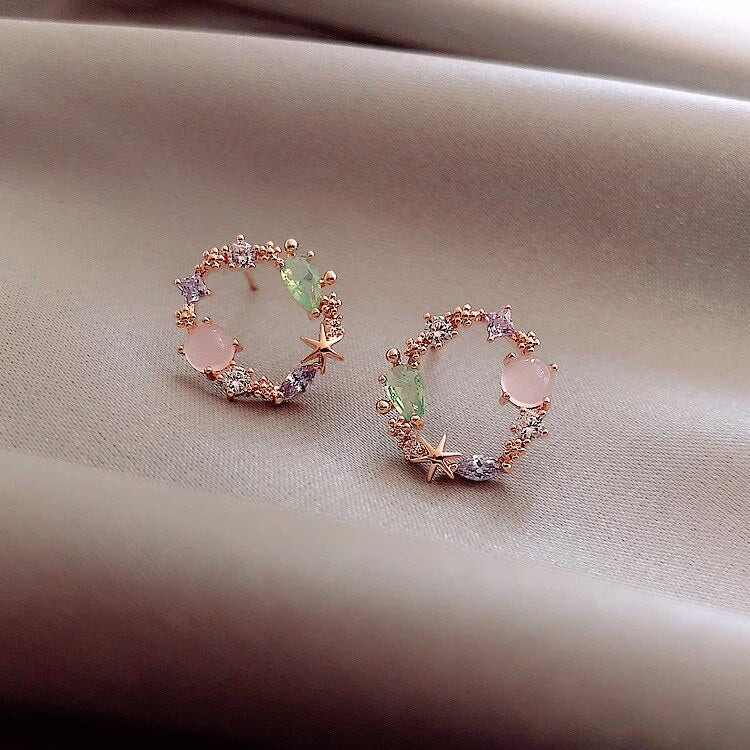 Elegant gold-plated flower earrings for women, featuring dainty floral design & sparkling zirconia.