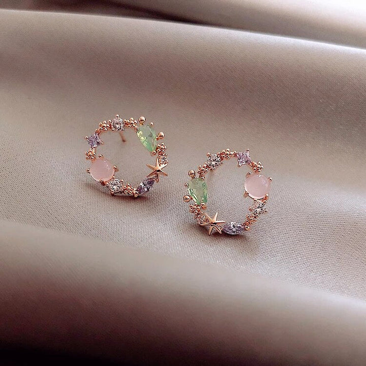 Elegant gold-plated flower earrings for women, featuring dainty floral design & sparkling zirconia.