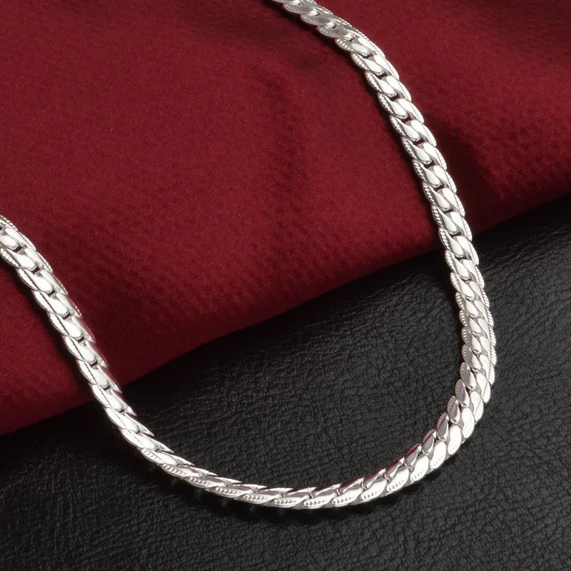 Close-up of a sparkling sterling silver chain necklace. Dainty and elegant women's jewelry, a perfect accessory.