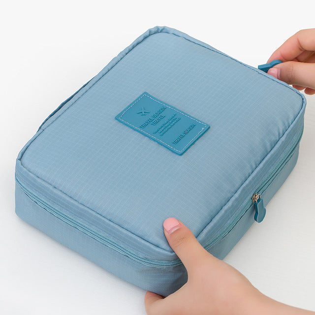 Women's waterproof beauty storage bag, dark blue floral, compact design.