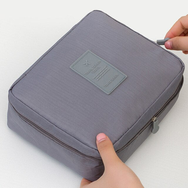 Women's waterproof makeup organizer, dark blue floral pattern, durable.